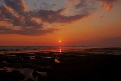 Scenic view of sea against romantic sky at sunset