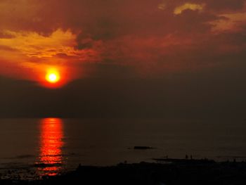 Scenic view of sea against orange sky