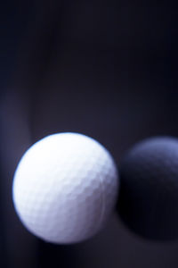 Close-up of ball on table against black background