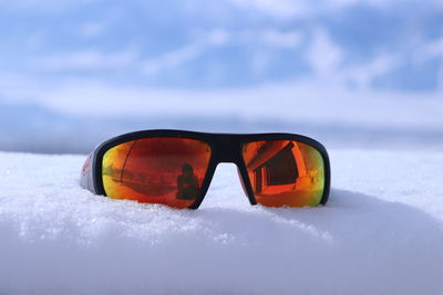 Close-up of sunglasses on snow