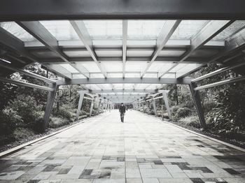 Man walking in covered walkway