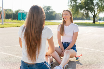 Two teenage sisters hanging out on a sunny day