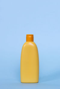 Close-up of bottles against blue background