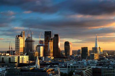 View of cityscape against cloudy sky