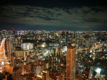 Illuminated cityscape against sky at night