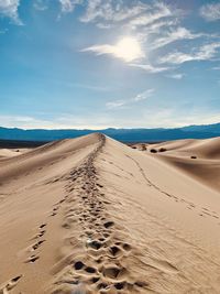 Sand dune in desert against sky