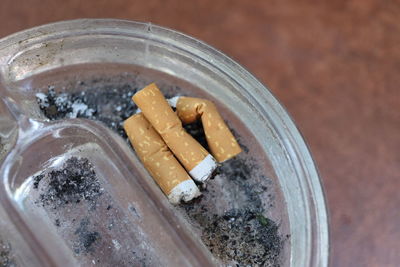 High angle view of cigarette smoking on table
