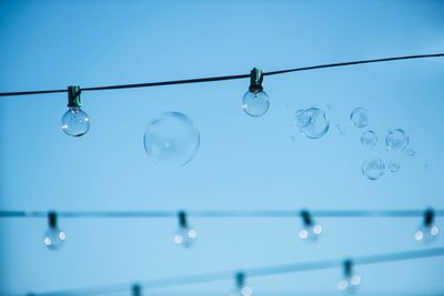 Low angle view of bubbles against clear sky