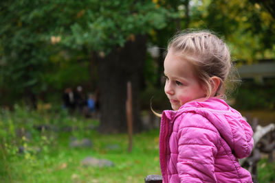 Side view of boy standing outdoors