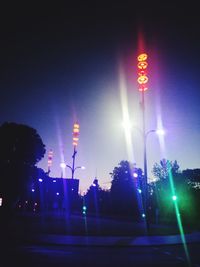 Low angle view of illuminated street light against sky