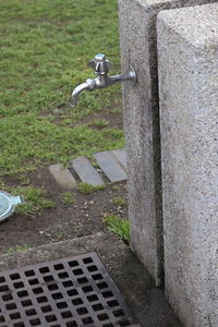 High angle view of faucet on footpath