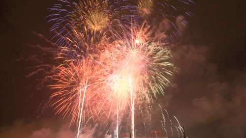 Low angle view of firework display at night