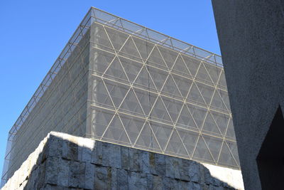 Low angle view of modern building against clear blue sky