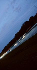 Light trails against blue sky at dusk