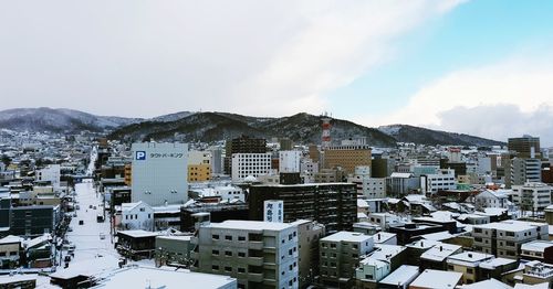 High angle view of buildings in city against sky