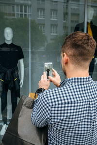 Rear view of man photographing