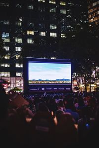 Crowd at music concert in city at night