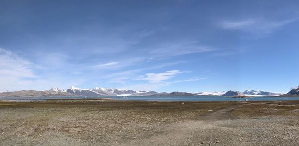 Scenic view of snowcapped mountains against blue sky