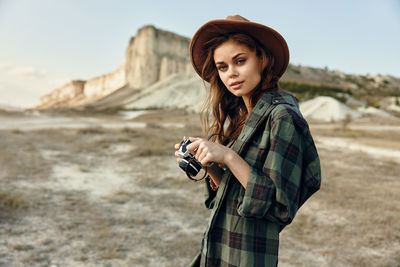 Young woman holding camera