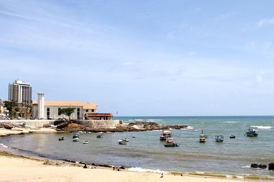 People on beach against sky