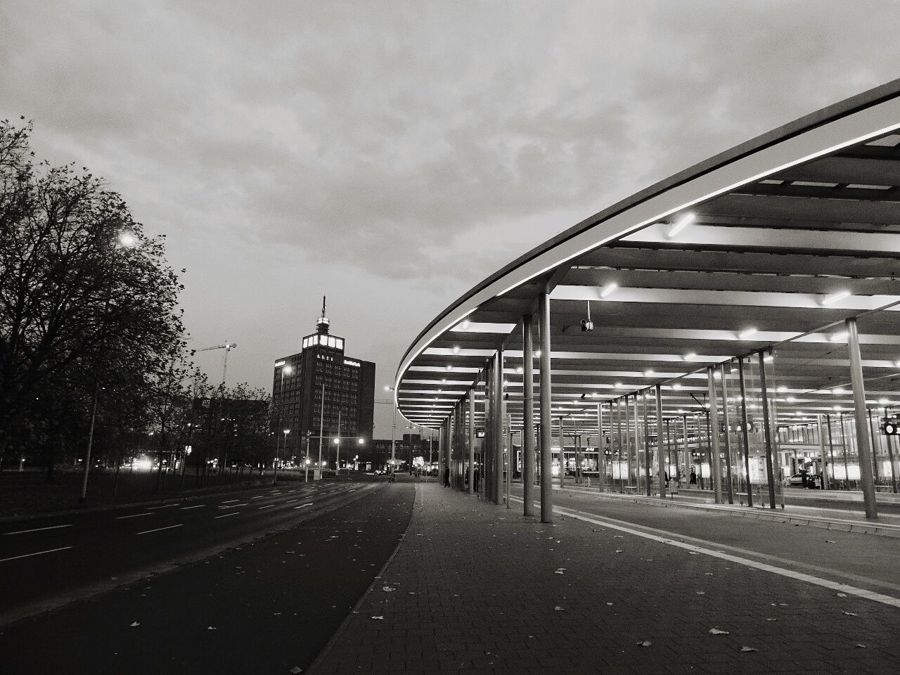 architecture, built structure, transportation, the way forward, sky, diminishing perspective, road, building exterior, cloud - sky, vanishing point, connection, bridge - man made structure, road marking, city, cloudy, street, empty, street light, cloud, incidental people