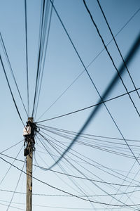 Low angle view of electricity pylon against sky