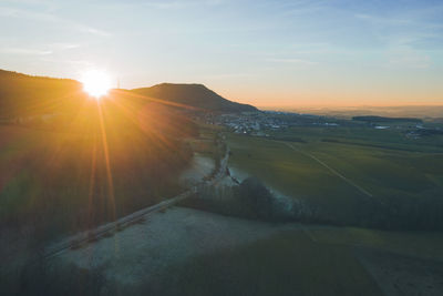 Aerial, panoramic view of a country road in a rural area at sunset