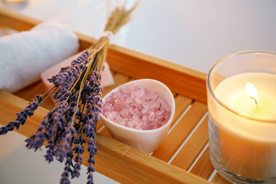 Spiritual aura cleansing ritual bath for full moon ritual. candles, aroma salt and lavender on tub 