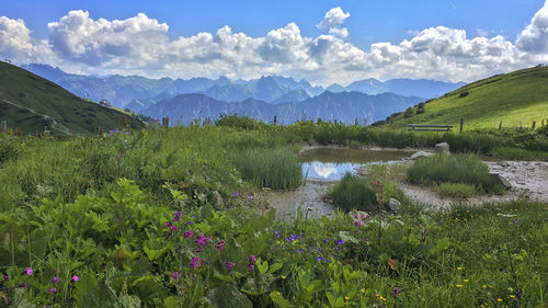 Scenic view of lake and mountains against sky