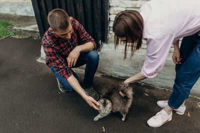 People with dog on street