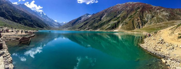 Panoramic view of lake and mountains against blue sky