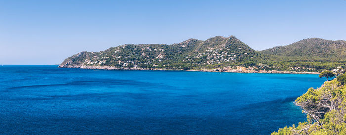 Scenic view of sea against clear blue sky