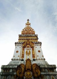 Low angle view of replica phra that phanom  against sky