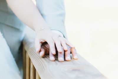 Cropped image of couple on railing