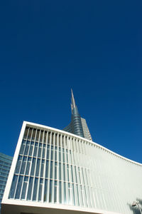 Low angle view of modern building against clear blue sky