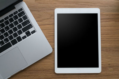 High angle view of laptop and digital tablet on table