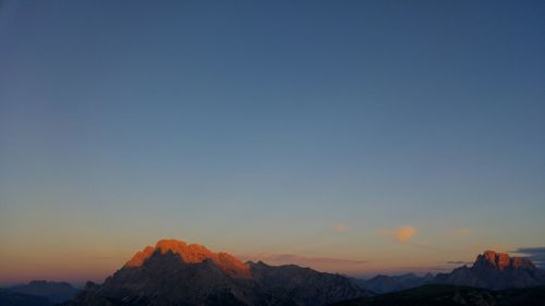 Scenic view of mountains against clear sky during sunset