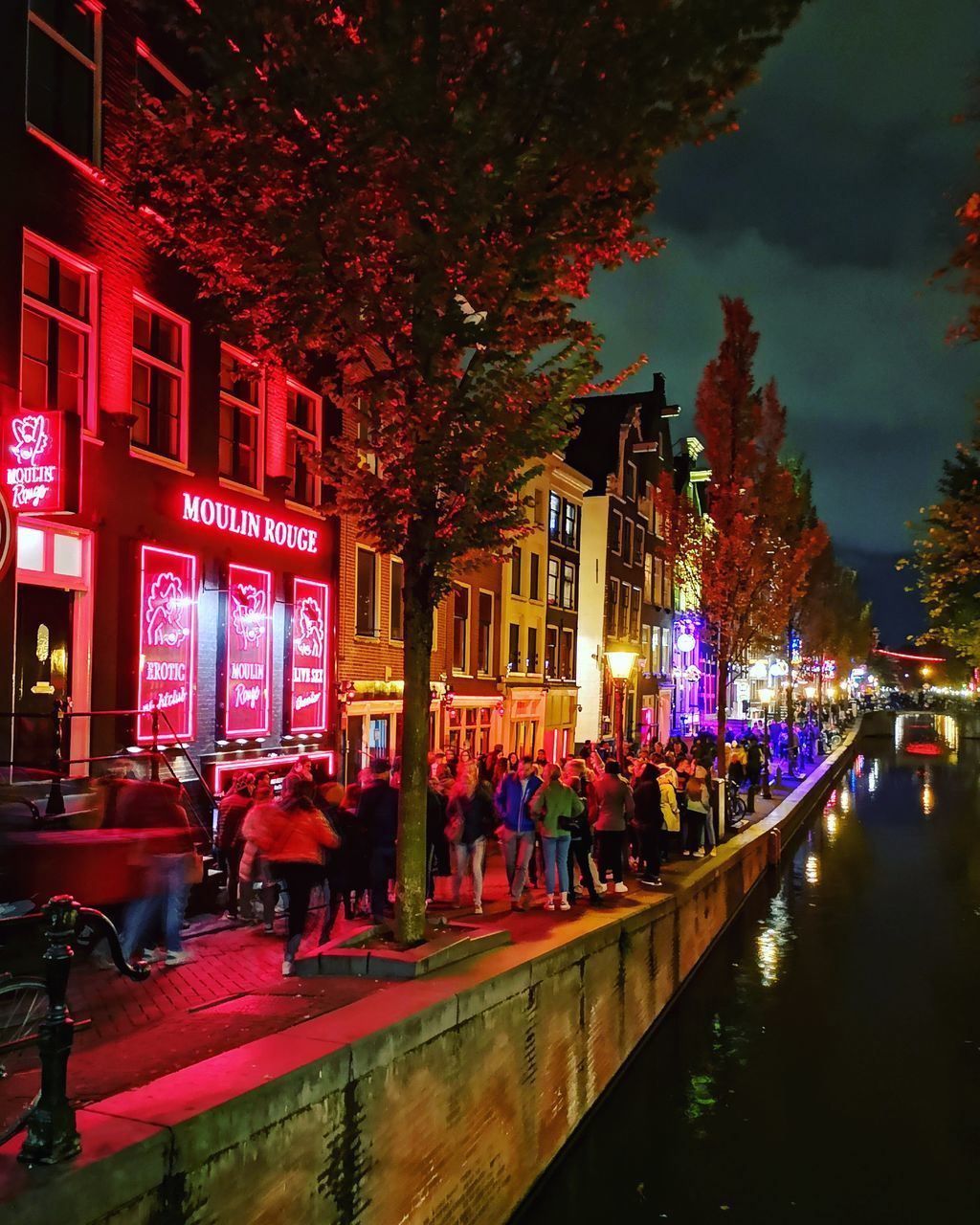 PEOPLE ON ILLUMINATED BUILDING AT NIGHT