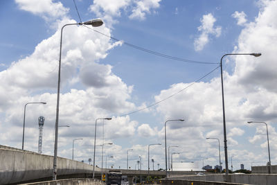 Low angle view of street lights against sky