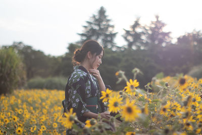 Young woman standing on field