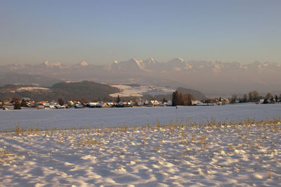 Scenic view of snow covered field against sky