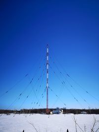 Scenic view of snow covered field against clear blue sky