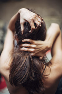 Portrait of woman with hands in hair