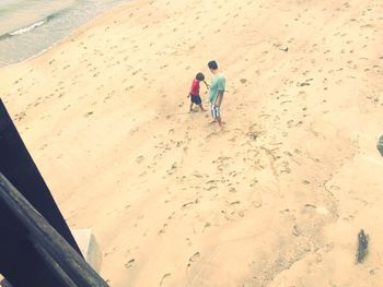 High angle view of cute girl on sand