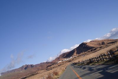 Scenic view of snowcapped mountains against blue sky