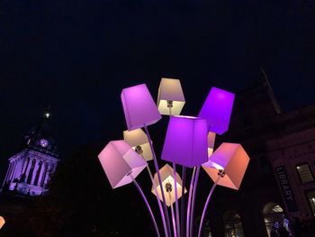 Close-up of illuminated lighting equipment against black background