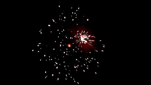 Low angle view of firework display at night