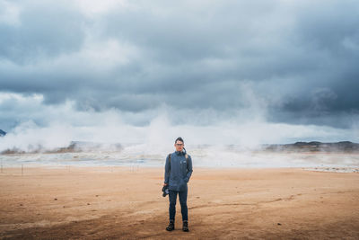 Full length rear view of man standing on beach