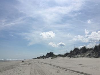 Scenic view of sandy beach against sky