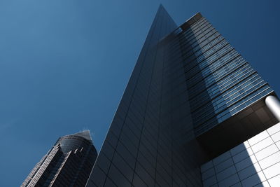 Low angle view of messeturm against blue sky